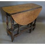 An 18th Century Oak Oval Gateleg Dining Table, with baluster turned legs and stretchers,