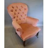 An Upholstered Drawing Room Chair with a button upholstered back raised upon turned legs with brass