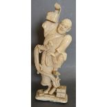 A 19th Century Japanese Carved Ivory Okimono in the form of a Man with a Serpent,