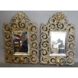 A Pair of Late 19th Early 20th Century Patinated Bronze Wall Mirrors of Scroll Form,