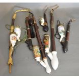 A Collection of German Porcelain and Horn Mounted Pipes
