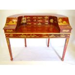 A Red Lacquered Chinoiserie Decorated Carlton House Desk with an arrangement of drawers and