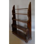 A 19th Century Rosewood Carved Waterfall Bookcase with carved ends and low turned feet,