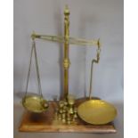 A Pair of Large Brass Balance Scales with rectangular wooden base inscribed Rackliffe, Guildford,