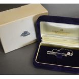 A Mikimoto Tie Clip in the form of a Golf Club with Pearl