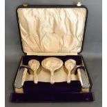 An Art Deco Five Piece Silver Backed Dressing Table Set retailed by Walker & Hall within fitted