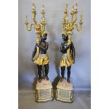A Pair of Floor Standing Blackamoor Candelabrum each with six scroll branches above figural