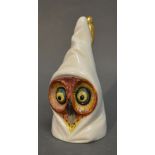 An Early 20th Century Royal Worcester Candle Snuffer in the form of a hooded owl, puce mark,