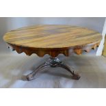 A Victorian Rosewood Centre Table with a shaped frieze raised upon a carved centre column with