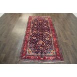 A North West Persian Woollen Rug with an all over design upon a blue,