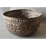 An Indian White Metal Large Bowl decorated in relief with animals amongst foliage, 27 cms diameter,