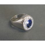 An 18ct White Gold Sapphire and Diamond Cluster Ring with a central oval sapphire surrounded by