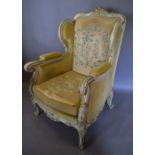 An Early 20th Century French Cream and Gilded Wingback Armchair,