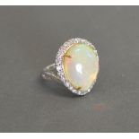 An 18ct White Gold Opal and Diamond Cluster Ring, the pear shaped opal approximately 10.
