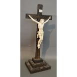 An Early 20th Century Carved Ivory model of Christ upon a hardwood crucifix with stepped base,
