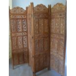 A Large Carved Hardwood Four Fold Screen, the panels pierced with grapevine,