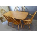An Ercol Blonde Dining Suite comprising a refectory style dining table and six high stick back