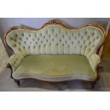 A Victorian Carved Walnut Serpentine Double Spoon Back Sofa,