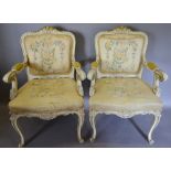A Pair of Early 20th Century French Cream and Gilded Fauteuils,
