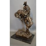 After Frederic Remington OUTLAW A patinated bronze on rectangular marble base,