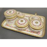 A Porcelain Dressing Table Set hand painted with Roses and highlighted with gilt