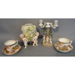 A German Porcelain Two Branch Candelabrum mounted with Putti,