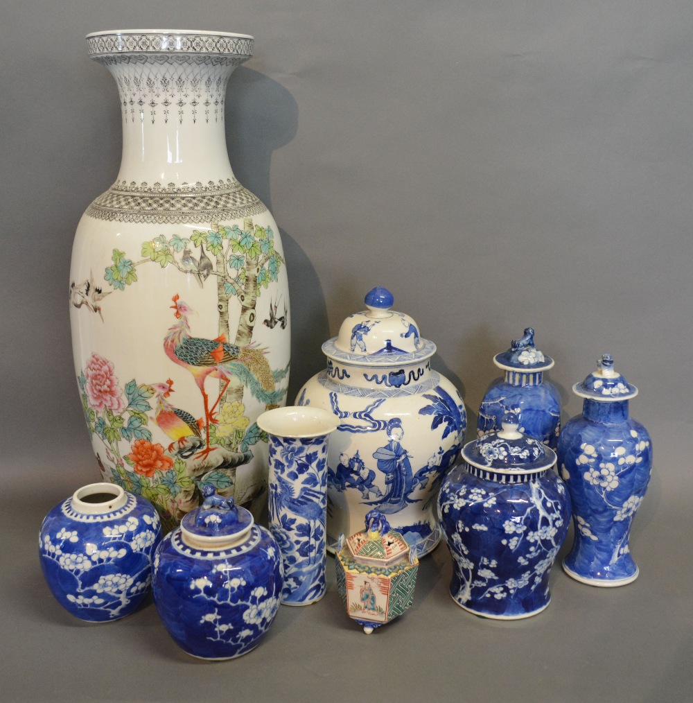 A Chinese Blue and White Bulbous Shaped Covered Vase decorated with figures within landscapes