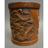 A Chinese Patinated Bronze Brush Pot, decorated in relief with a serpent, seal mark to base,