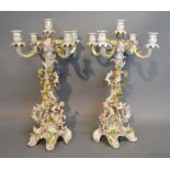 A Pair of German Porcelain Candelabrum each with figural mounts and foliate encrusted decoration,