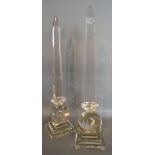 A Pair of Glass Obelisks with square stepped bases,