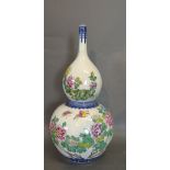 A Chinese Porcelain Double Gourd Vase with Famille Rose Decoration and Chinese Script,