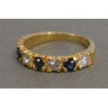 A 15ct. Gold Sapphire and Diamond Band R
