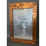 An Arts and Crafts Rectangular Copper Mirror, decorated with six embossed fleur de lis,