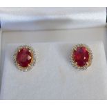 A Pair of Yellow Metal Oval Ruby and Diamond Cluster Ear Studs, rubies 4.56 ct, diamonds 0.