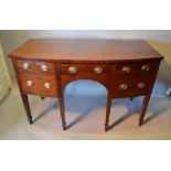 An Early 19th Century Bow Fronted Sideboard with a central drawer flanked by two drawers and