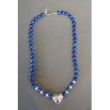 A Vibrant Blue Cultured Pearl Necklace with Silver Clasp in the form of a heart