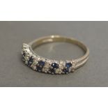 An 18ct White Gold Diamond and Sapphire Set Half Hoop Band Ring