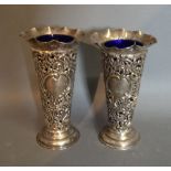 A Pair of Chester Silver Spill Vases of Pierced Scroll Form, each with a blue glass liner,