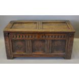 A 17th Century Oak Small Coffer, the hinged top above a three panel carved front flanked by stiles,