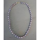 A Lilac Cultured Pearl Necklace, inter spaced with small amethyst and with 9ct.