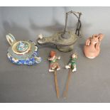 A Small Patinated Metal Oil Lamp, together with another similar oil lamp,