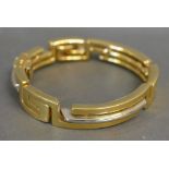An 18ct. White and Yellow Gold Bracelet of shaped linked form, marked 750, 53.
