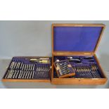 A Silver Plated Canteen of Cutlery, housed within an oak canteen cabinet,
