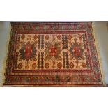 A North West Persian Woollen Rug with three central medallions within an all over design upon a