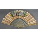 An Early Printed Leaf Fan, the blonde horn sticks inlaid with blue and silver medallions,