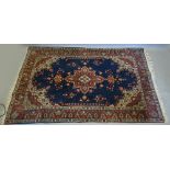 A North West Persian Style Woollen Rug with a central medallion upon a blue,