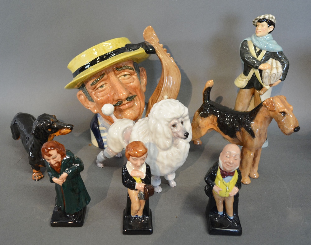 A Royal Doulton Figure 'News Boy' HN Number 2244 together with three Royal Doulton Figures of Dogs,