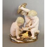 A 19th Century Meissen Porcelain Group in the form of Three Putti around a Fire,