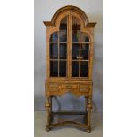 A Queen Anne Style Walnut Dome Cabinet, with two arched glazed doors enclosing shelves,