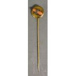 A Yellow Metal Stick Pin mounted with a band of Diamonds around Coral